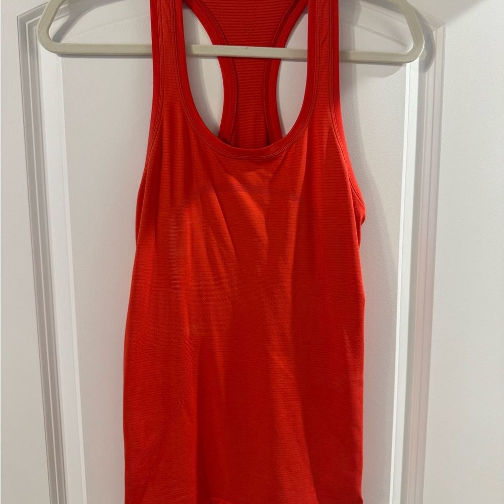 Lululemon Swiftly tank, hip length. Size 4. Like new. Brighter orange